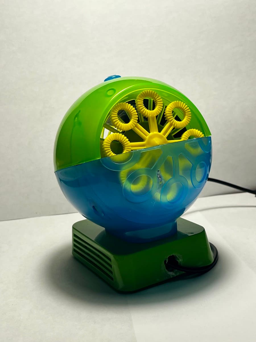 A finished switch-adapted bubble machine printed in green and translucent blue.